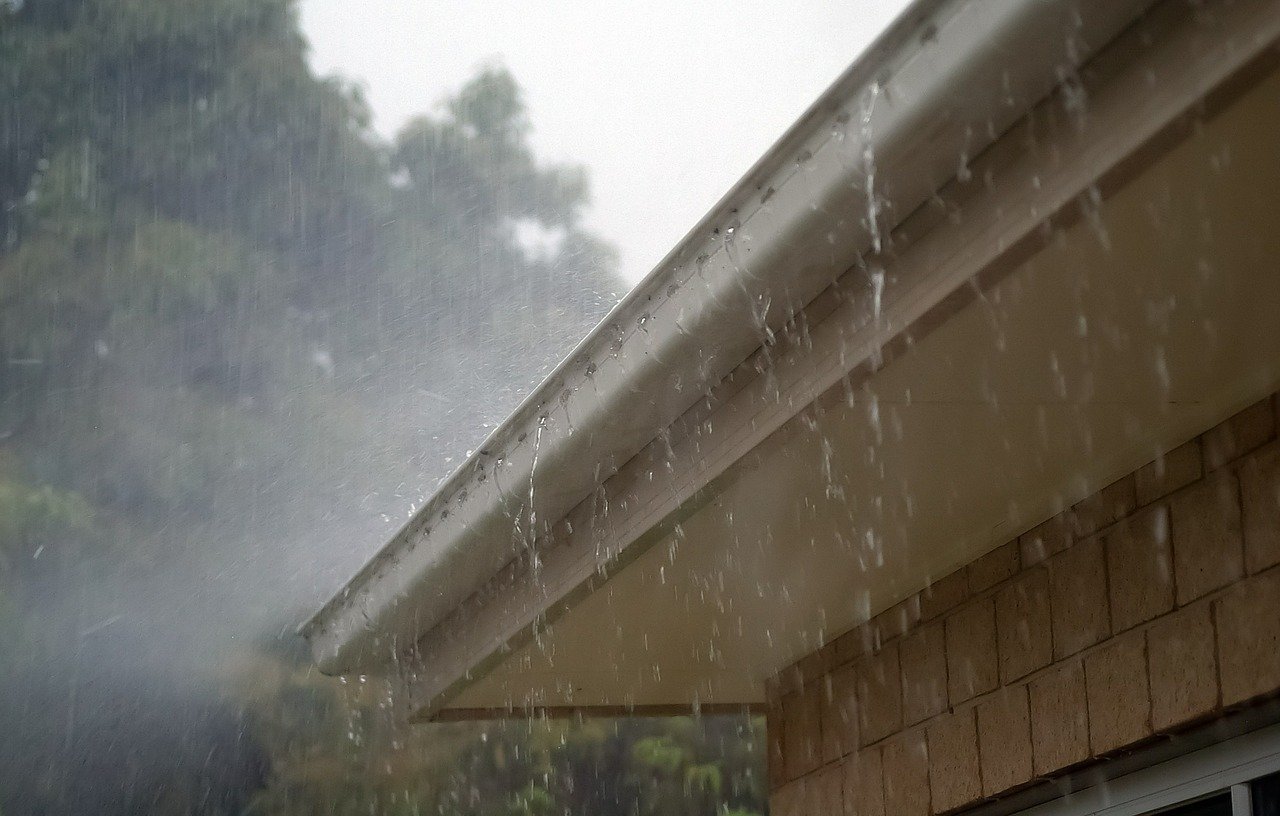 Image of a white gutter being rained on