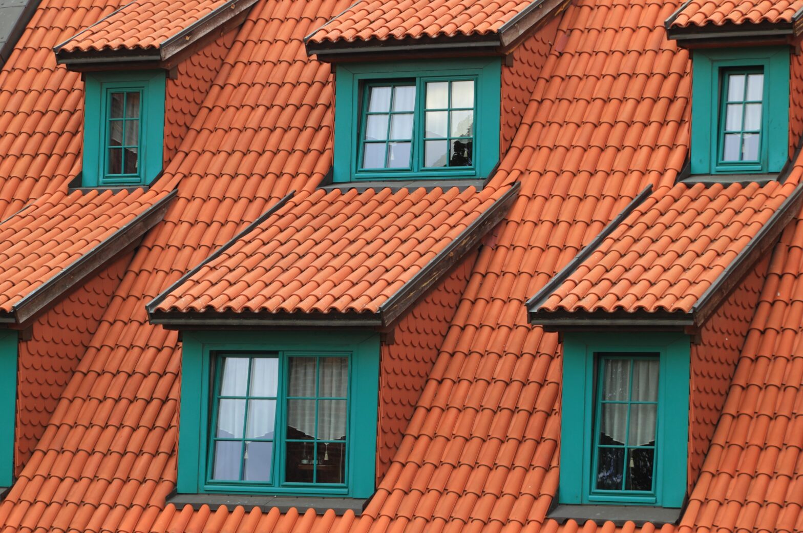 An image of an orange tiled roof and windows