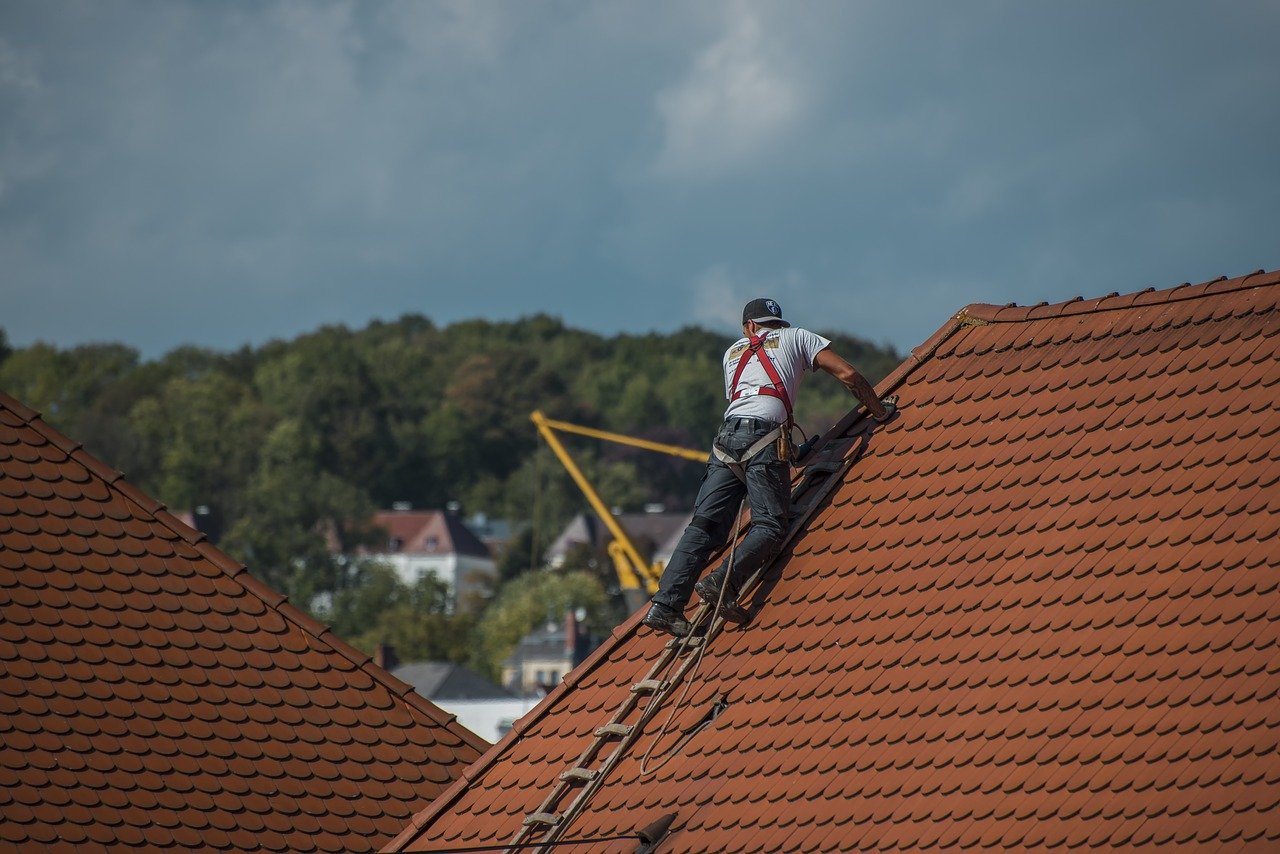 A man working on top of a roof