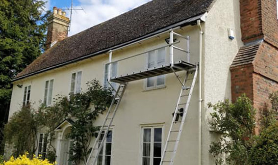 scaffolding leading to roof of semi-detached house