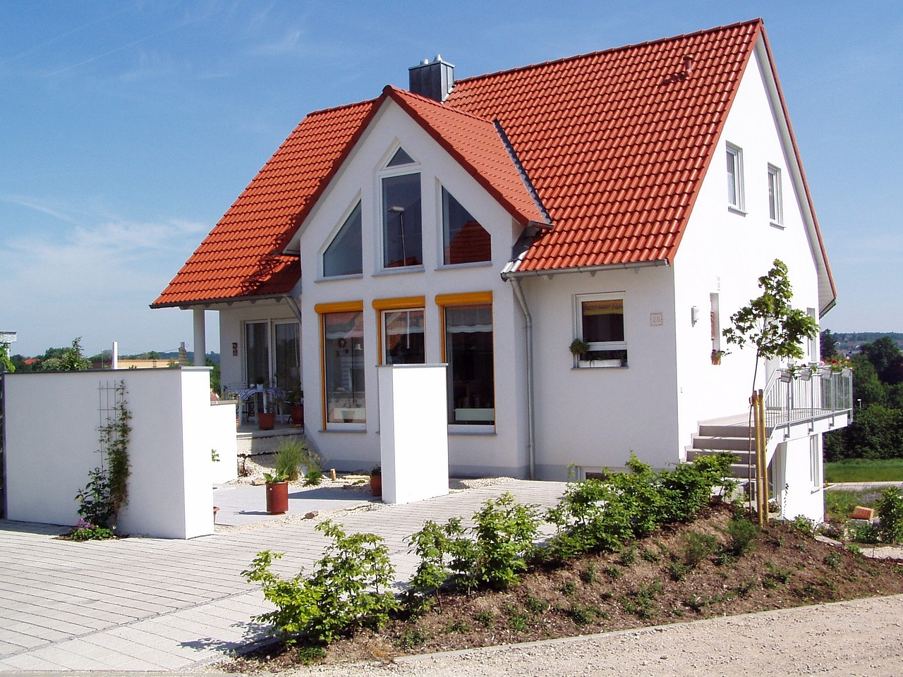 A white house with terracotta roofing