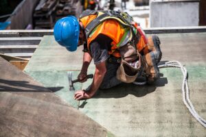 image of a man working on a roof
